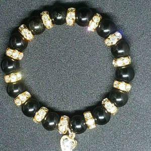 Black and gold bracelet with gold heart charm